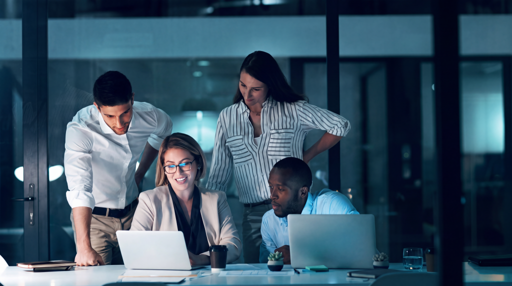 Group of Business professionals discussing while looking at the data on a laptop